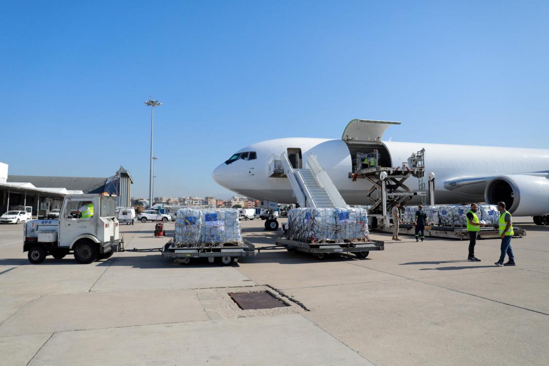 Above, workers unload a humanitarian aid shipment at the Beirut International Airport on Oct. 15, 2024. (AFP)
