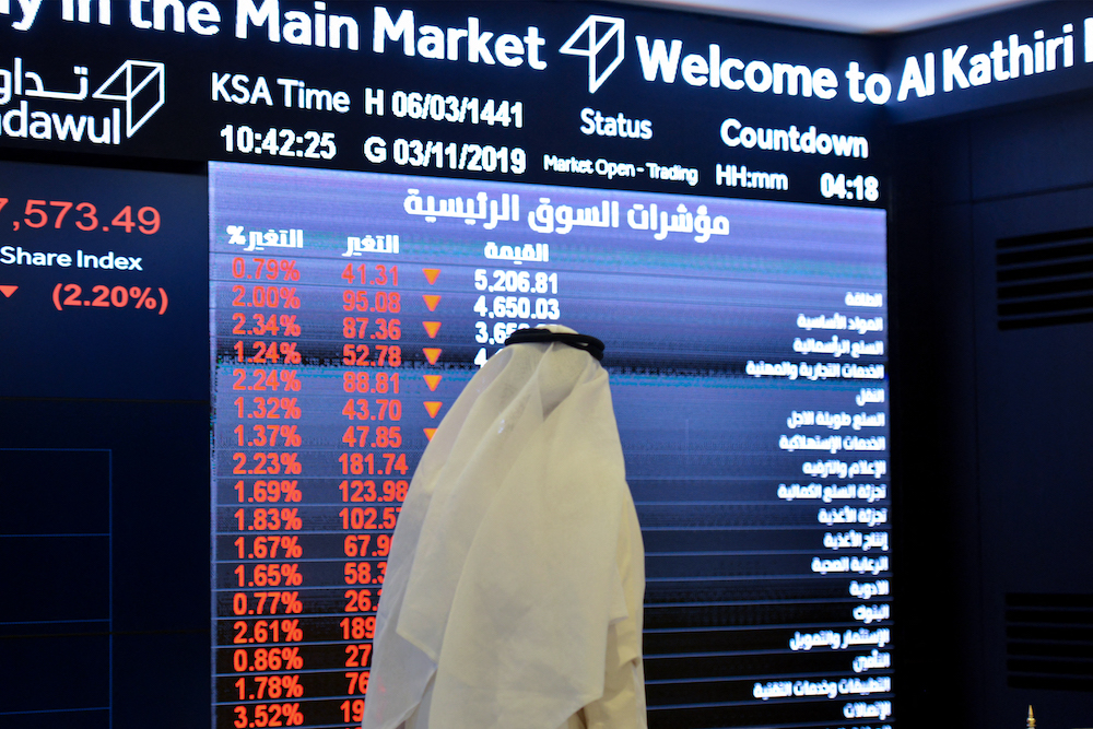 A Saudi man monitors stock prices at Tadawul Saudi bourse in Riyadh. File/AFP