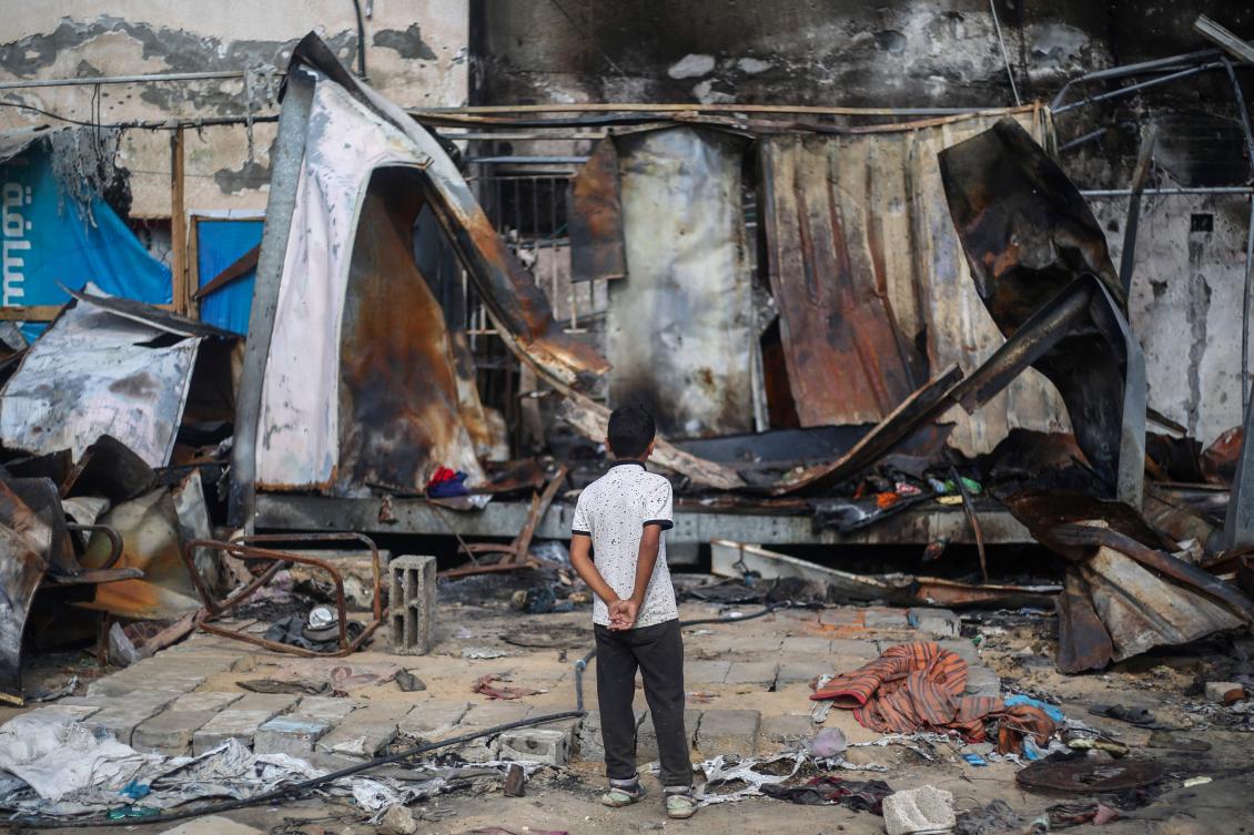 Palestinian boy looks at destroyed shelters at the site of an Israeli airstrike which hit tents for displaced people two days earlier in the courtyard of Al-Aqsa Martyrs Hospital in Deir al-Balah in the central Gaza Strip on October 16, 2024. (AFP)