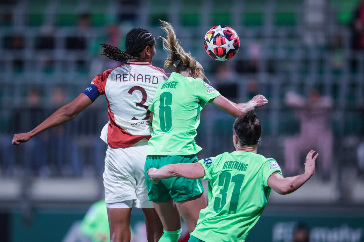 Lyon's French defender Wendie Renard (L) heads the ball to score the opening goal during the UEFA Women's Champions League Group A preliminary round football match between VfL Wolfsburg and Olympique Lyonnais in Wolfsburg, northern Germany on Oct. 17, 2024. (AFP)