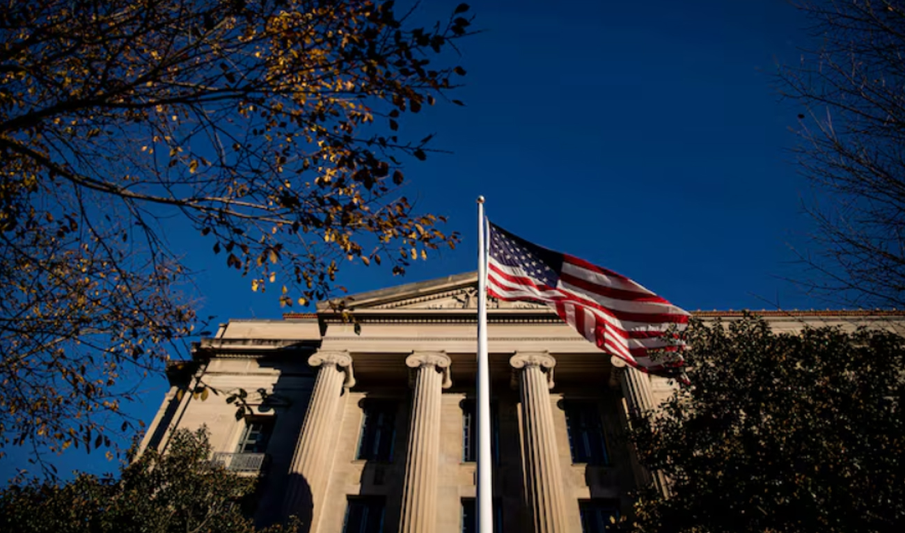 An American flag waves outside the US Department of Justice Building in Washington, US, December 15, 2020. (REUTERS/File)