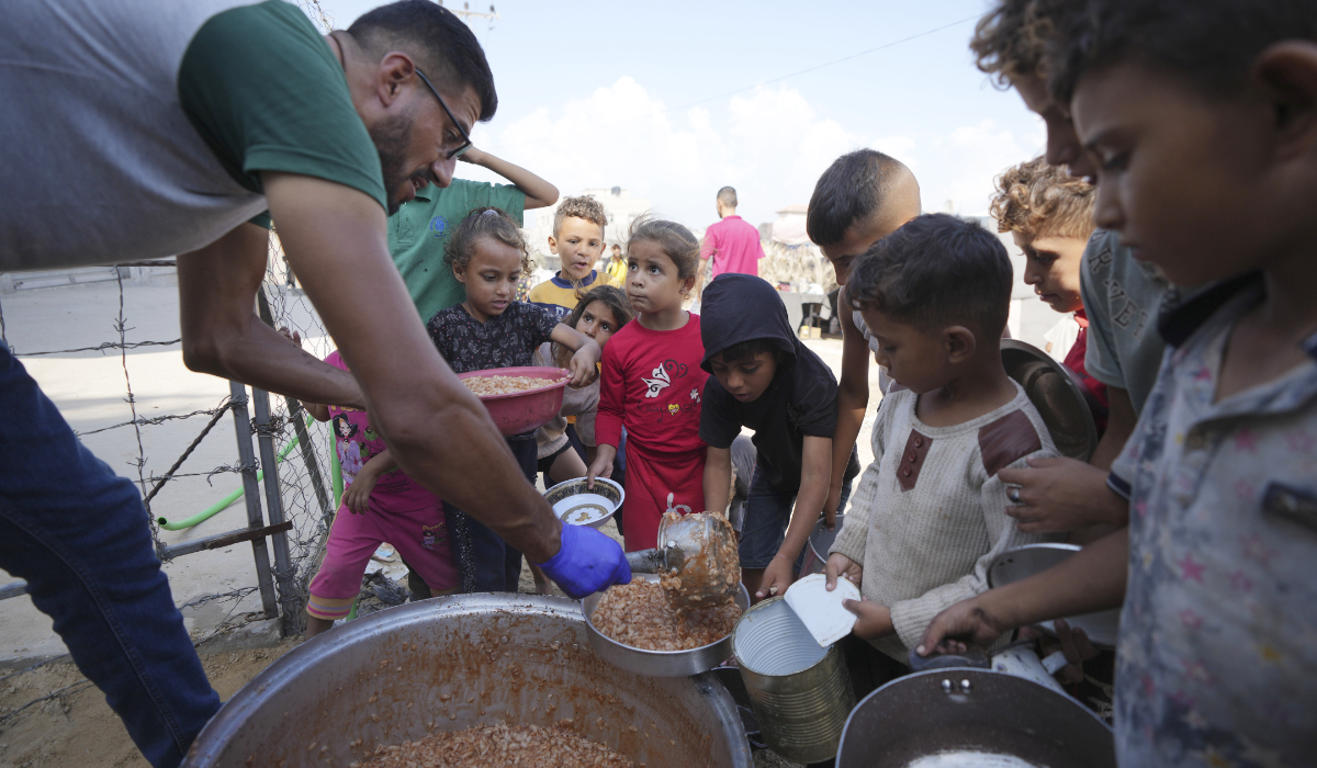 Displaced Palestinian children queue for food in a camp in Deir al-Balah, Gaza Strip, Friday, Oct. 18, 2024. (AP)