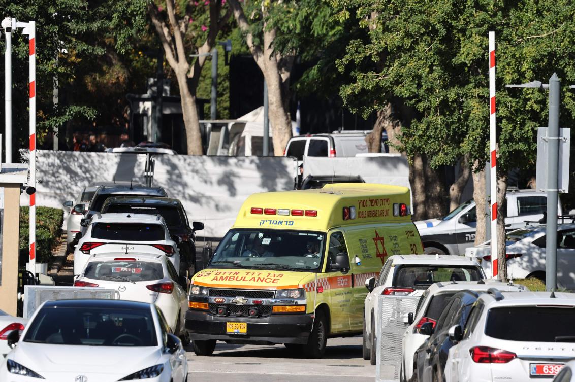 An ambulance drives behind a barrier across a street leading to Prime Minister Benjamin Netanyahu’s residence in Caesarea on Oct. 19, 2024. (AFP)