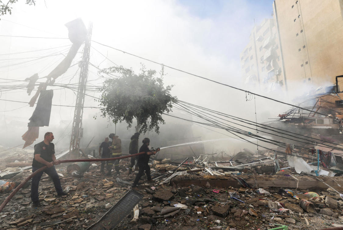 Civil defence members put out a fire at a damaged site, in the aftermath of Israeli strikes on Beirut's southern suburbs, Lebanon October 20, 2024. (REUTERS)