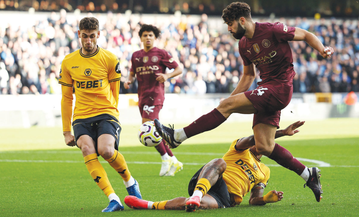 Stones bags controversial winner as Man City survive Wolves scare