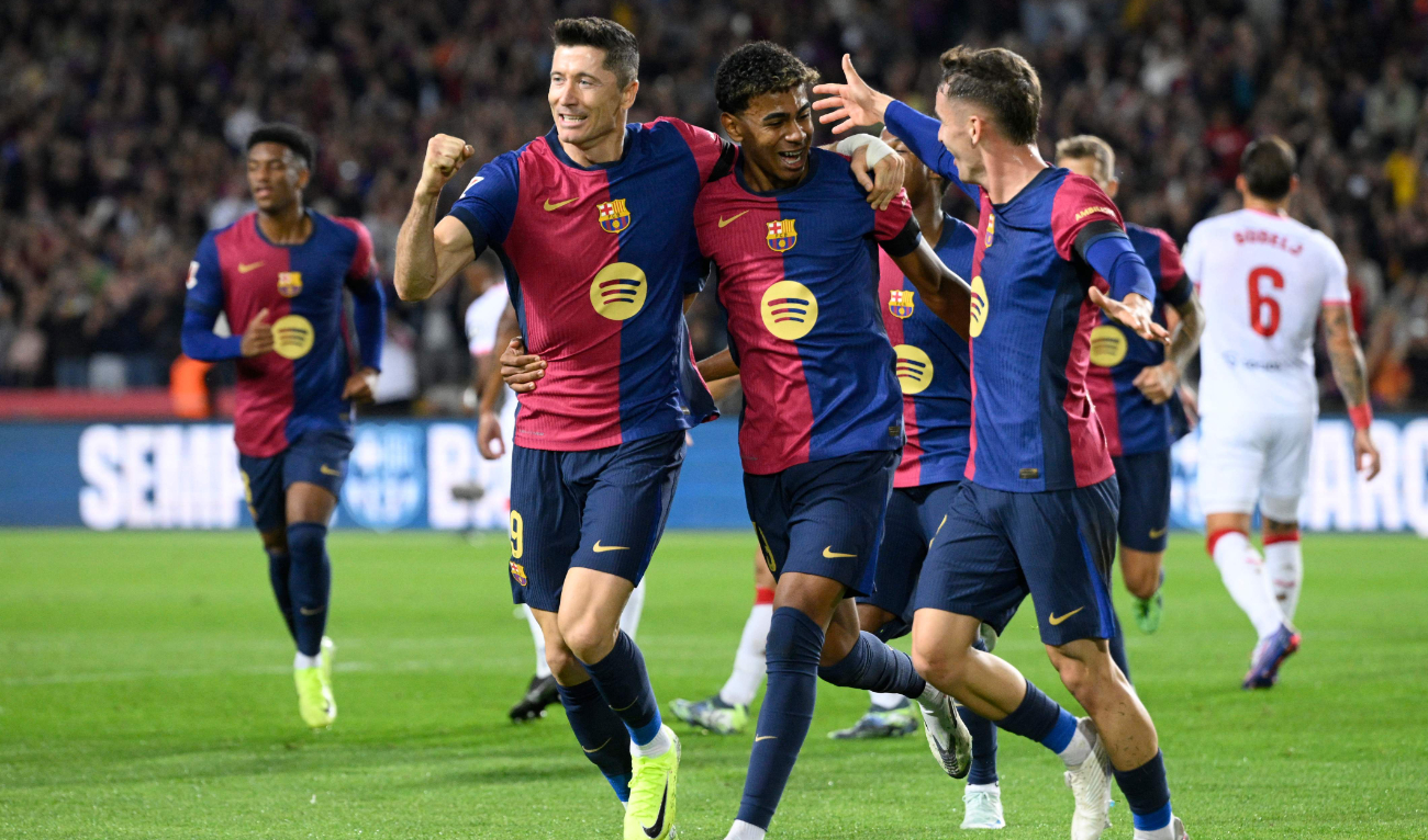 Barcelona's Polish forward #09 Robert Lewandowski (L) celebrates scoring the opening goal from the penalty spot during the Spanish league football match between FC Barcelona and Sevilla FC at the Estadi Olimpic Lluis Companys in Barcelona on October 20, 2024. (AFP)