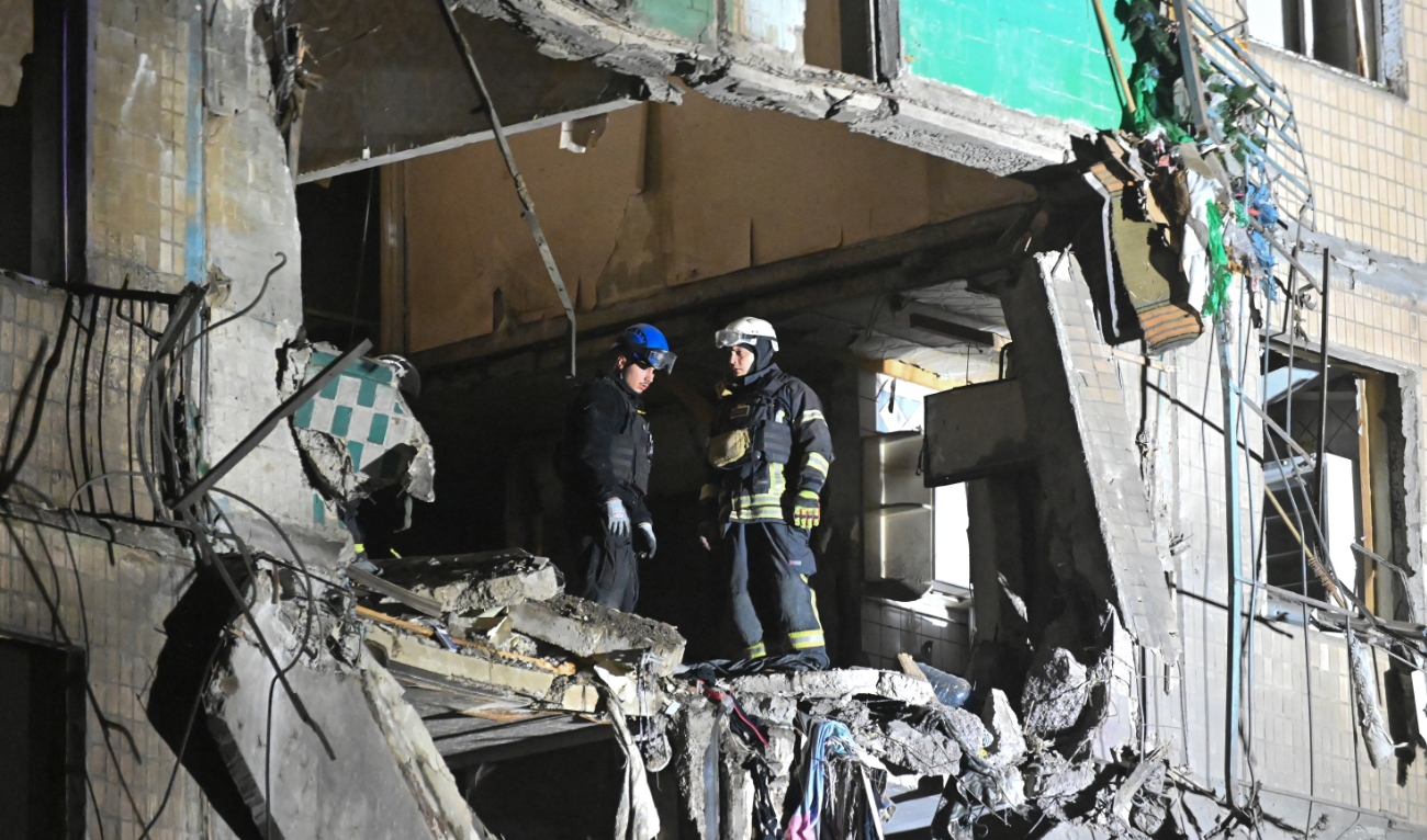 Ukrainian rescuers inspect damage to a residential building following a missile attack in Kharkiv early on October 3, 2024. (AFP/File)