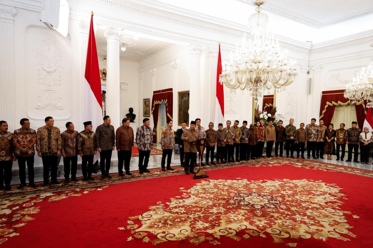 Newly appointed cabinet ministers stand behind Indonesia's new President Prabowo Subianto, center, as he announces his cabinet lineup at Merdeka Palace in Jakarta on Oct. 20, 2024. (AP)