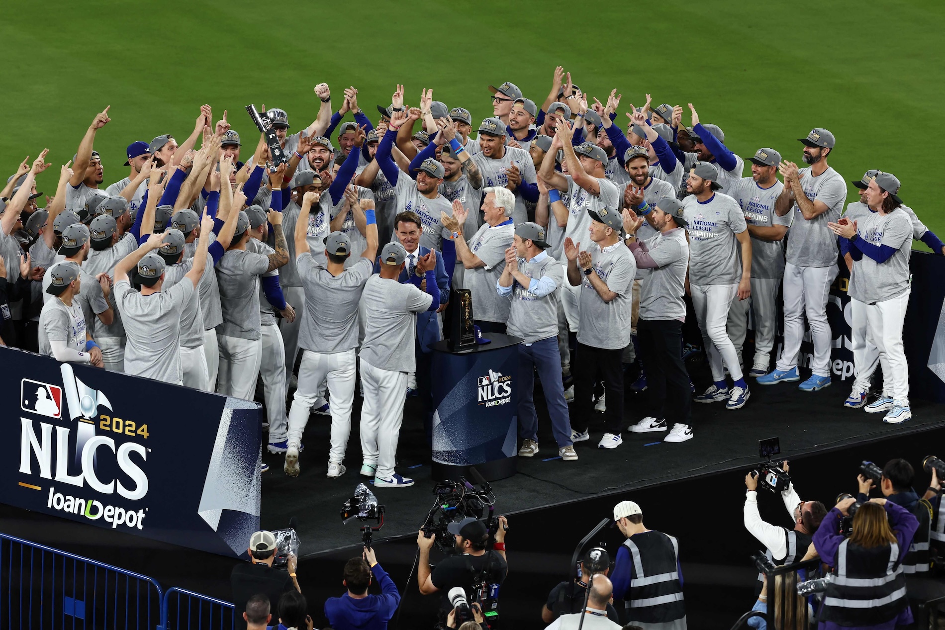 The Los Angeles Dodgers celebrate at a trophy ceremony after defeating the New York Mets to win Game 6 of the National League Championship Series at Dodger Stadium on Oct. 20, 2024 in Los Angeles, California. (AFP)