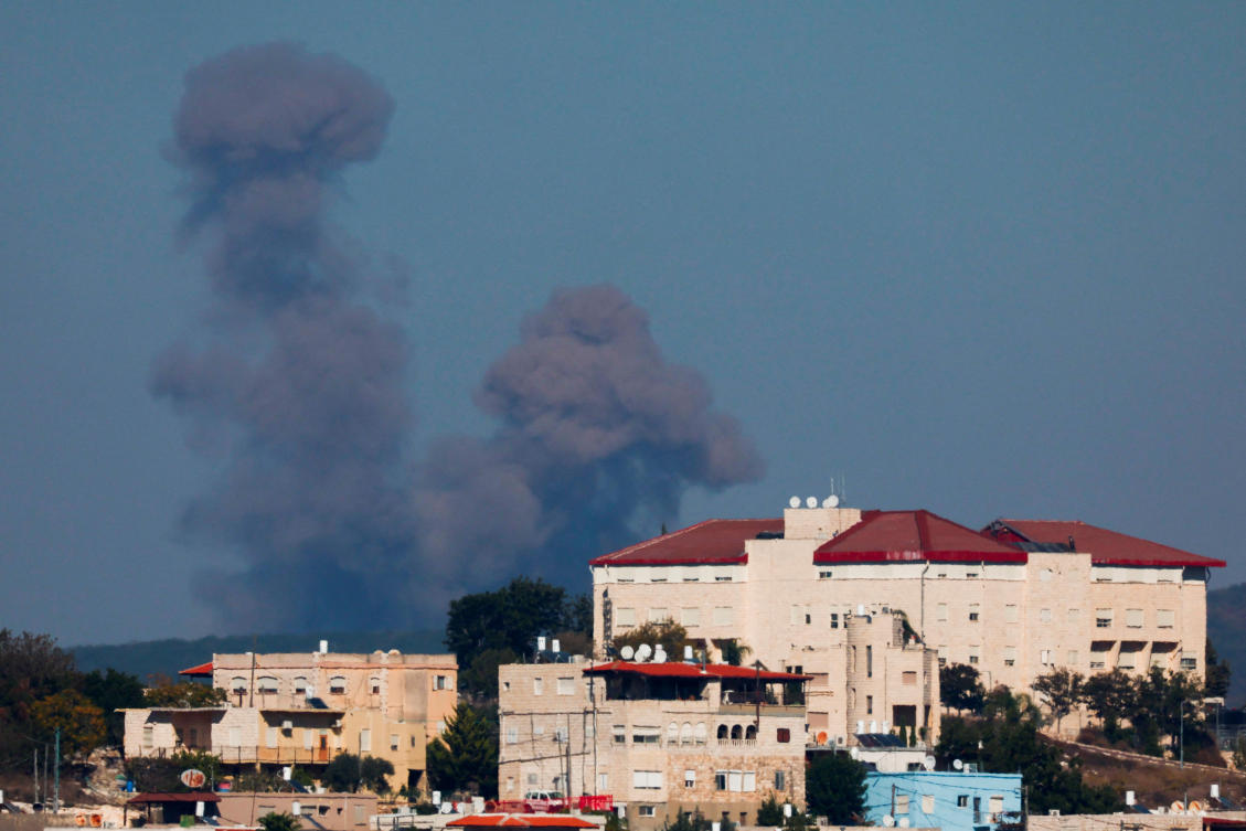 Smoke billows over southern Lebanon, behind the buildings in Mi'ilya, amid ongoing cross-border hostilities between Hezbollah and Israeli forces, as seen from near Ein Ya'akov, northern Israel October 21, 2024. (Reuters)