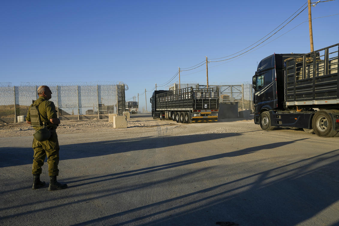 Trucks carrying humanitarian aid cross into the Gaza Strip from Erez crossing in southern Israel, Monday, Oct. 21, 2024. (AP)