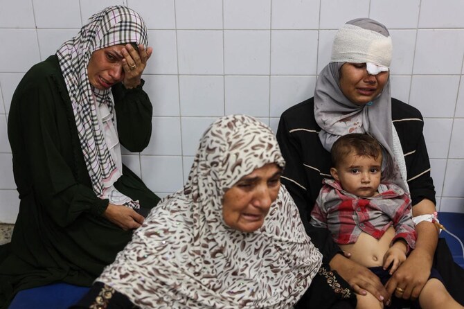 People who were injured during an Israeli operation in the Jabalia refugee camp in the central Gaza Strip await treatment at Al-Ahli Arab hospital in Gaza City on October 21, 2024. (AFP)