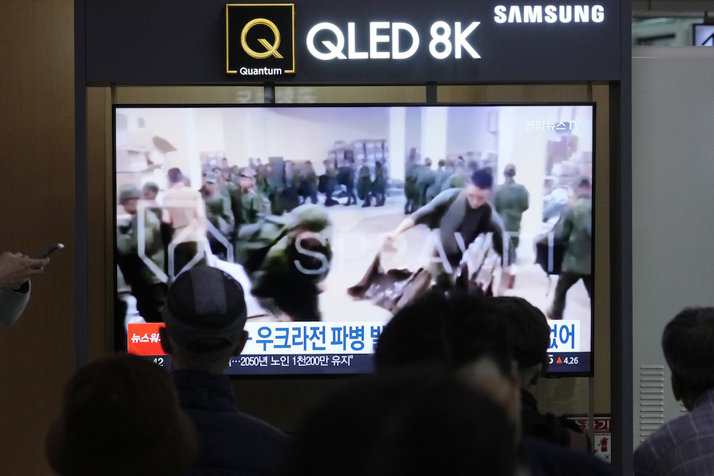 A TV screen shows an image of soldiers, believed to be from North Korea, stand in line to receive supplies from Russia during a news program at Seoul Railway Station in Seoul, South Korea on Oct. 21, 2024. (AP)