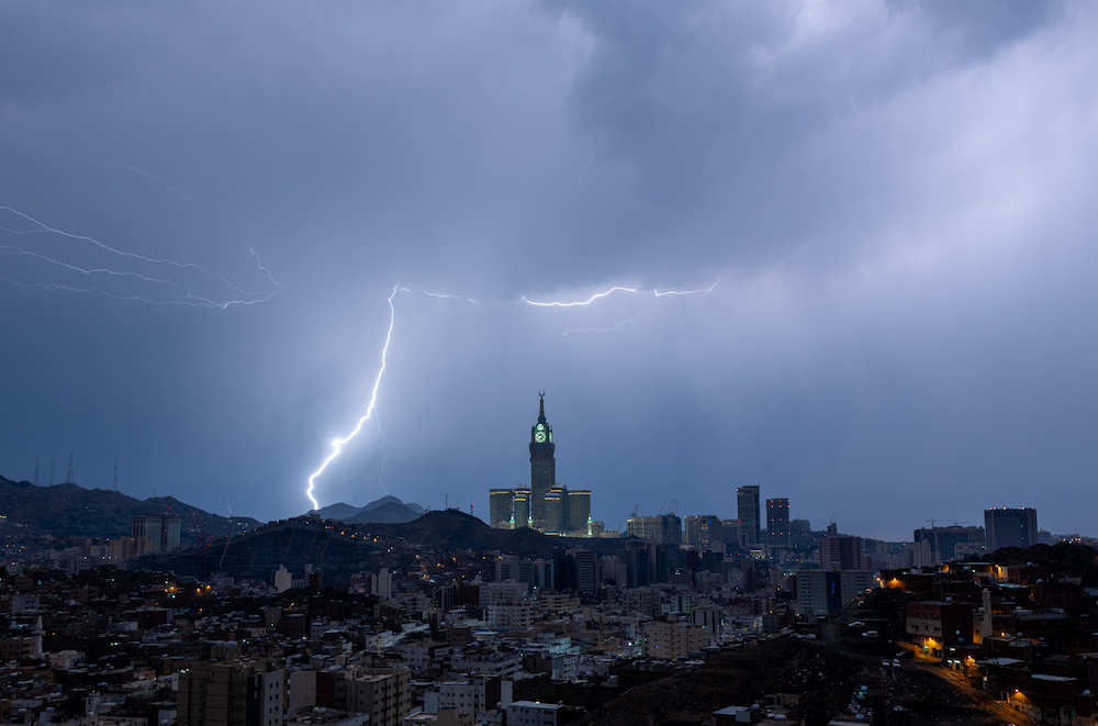 Autumn in Saudi Arabia is typically rainy, with rapid weather changes providing relief from the heat, according to the National Center for Meteorology. Above, lightning over Makkah’s clock tower on Aug. 22, 2023. (AFP file photo)