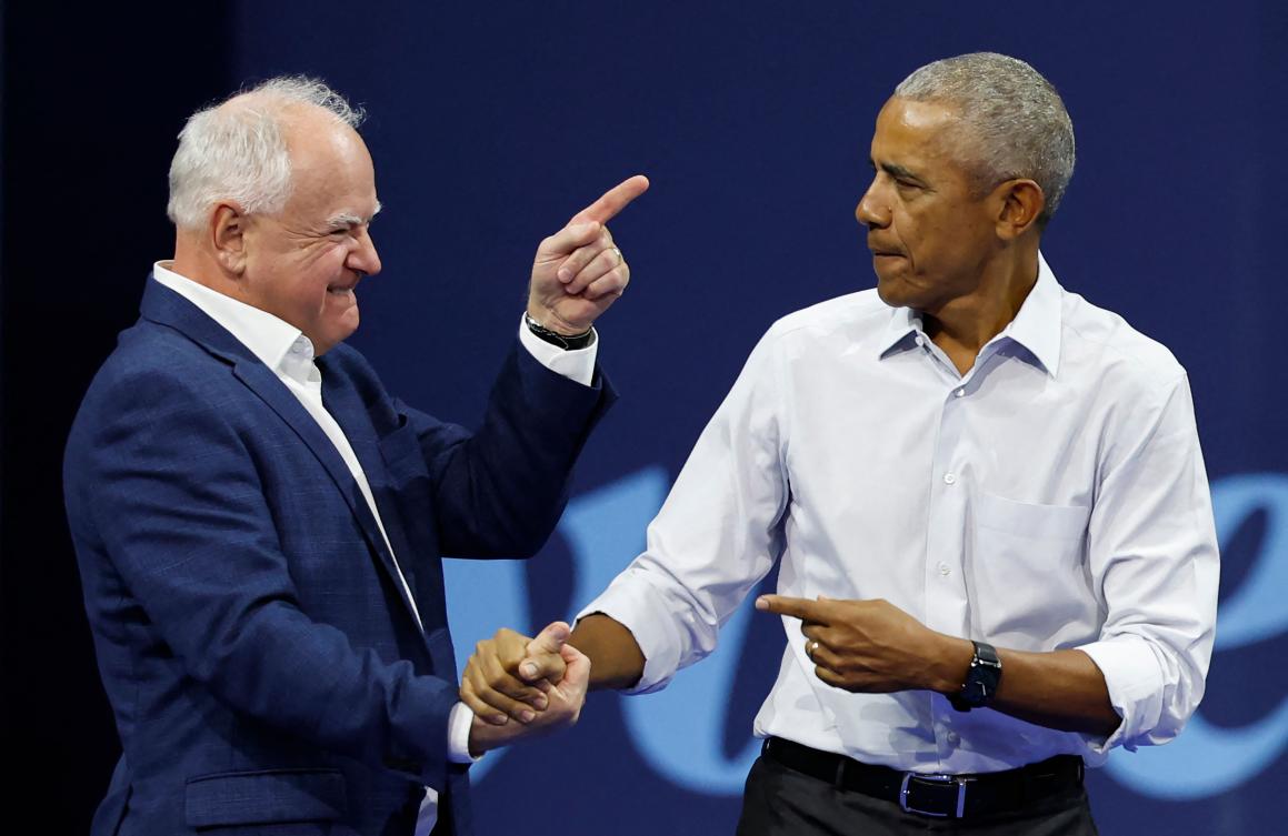 Former US President Barack Obama greets Minnesota Governor and Democratic vice presidential candidate Tim Walz during a campaign rally in support of Vice President and Democratic presidential candidate Kamala Harris, at Alliant Center in Madison, Wisconsin. (AFP)