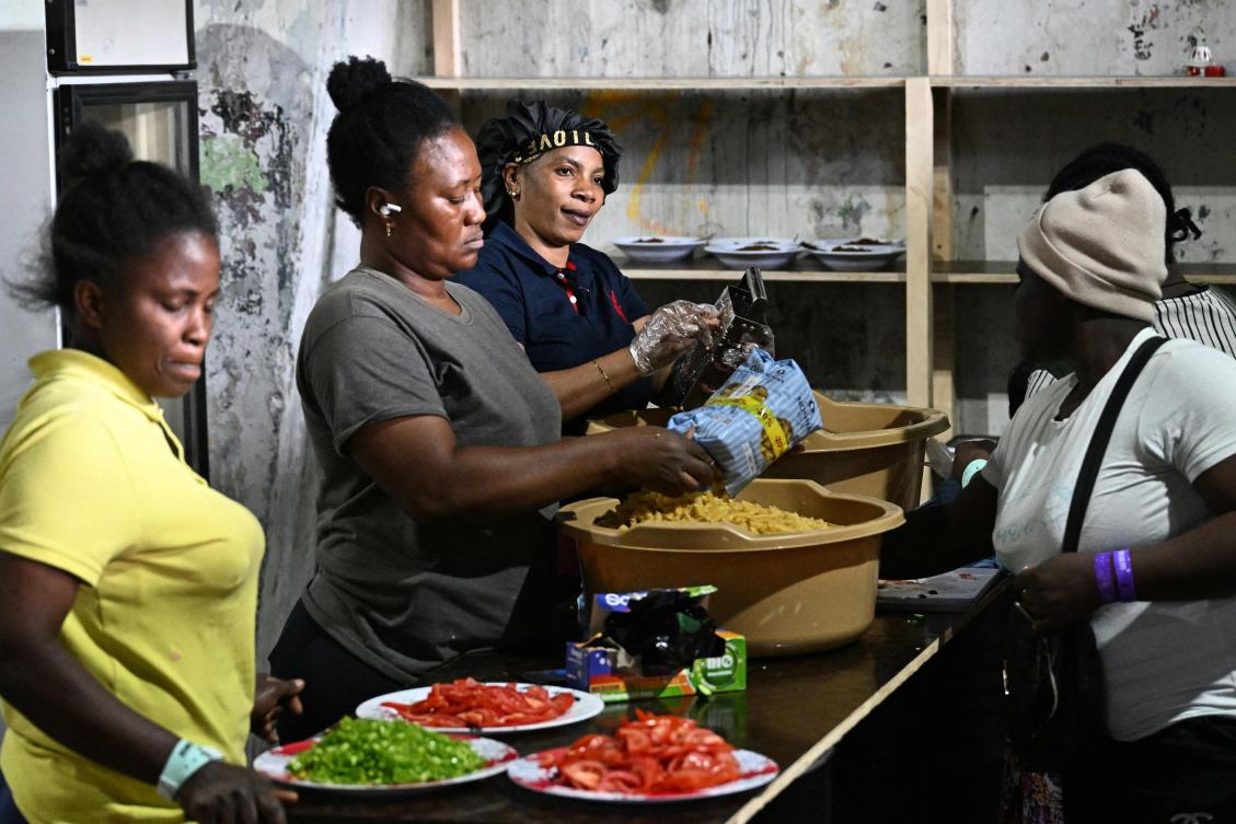 Displaced African migrant workers cook a meal at a warehouse, turned into a shelter by a group of volunteers to house migrant workers who fled Israeli bombardment in southern Lebanon, in the eastern suburbs of Beirut amid the ongoing war between Israel and Hezbollah. (AFP)