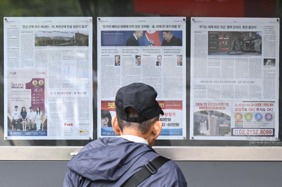 Above, a newspaper is displayed on a street for the public in Seoul on Oct. 21, 2024, with coverage on North Korea’s decision to deploy thousands of soldiers to Ukraine’s front lines. (AFP)