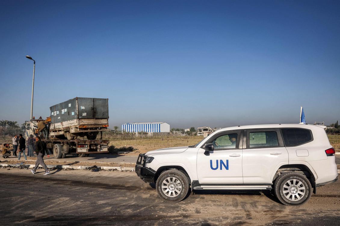 A UN vehicle is parked nearby as a destroyed UN agency for Palestinian refugees truck which was fired upon by Israeli forces earlier along Salah Al-Din road outside Deir El-Balah in the center of the Gaza Strip on Oct. 23, 2024. (AFP)