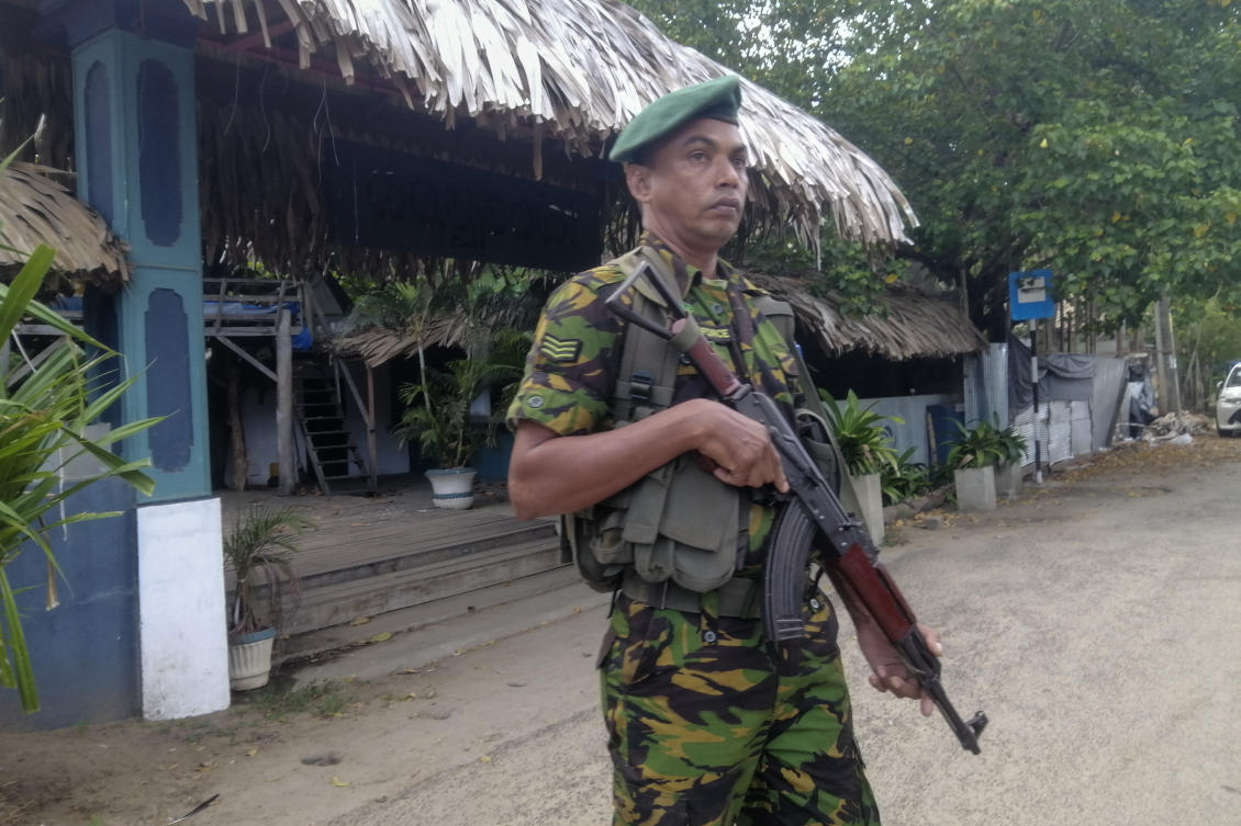 A police commando stands guard in front of a restaurant in Arugam Bay, Sri Lanka on Oct. 23, 2024. (AP)