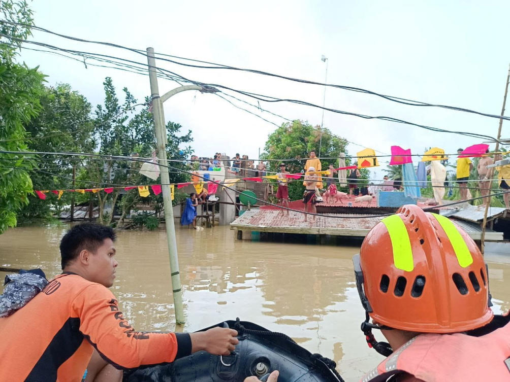 Philippine Coast Guard personnel rescue residents trapped on rooftops after flood waters rose from heavy rains brought by Tropical Storm Trami on Oct. 23, 2024. (Philippine Coast Guard via Reuters)