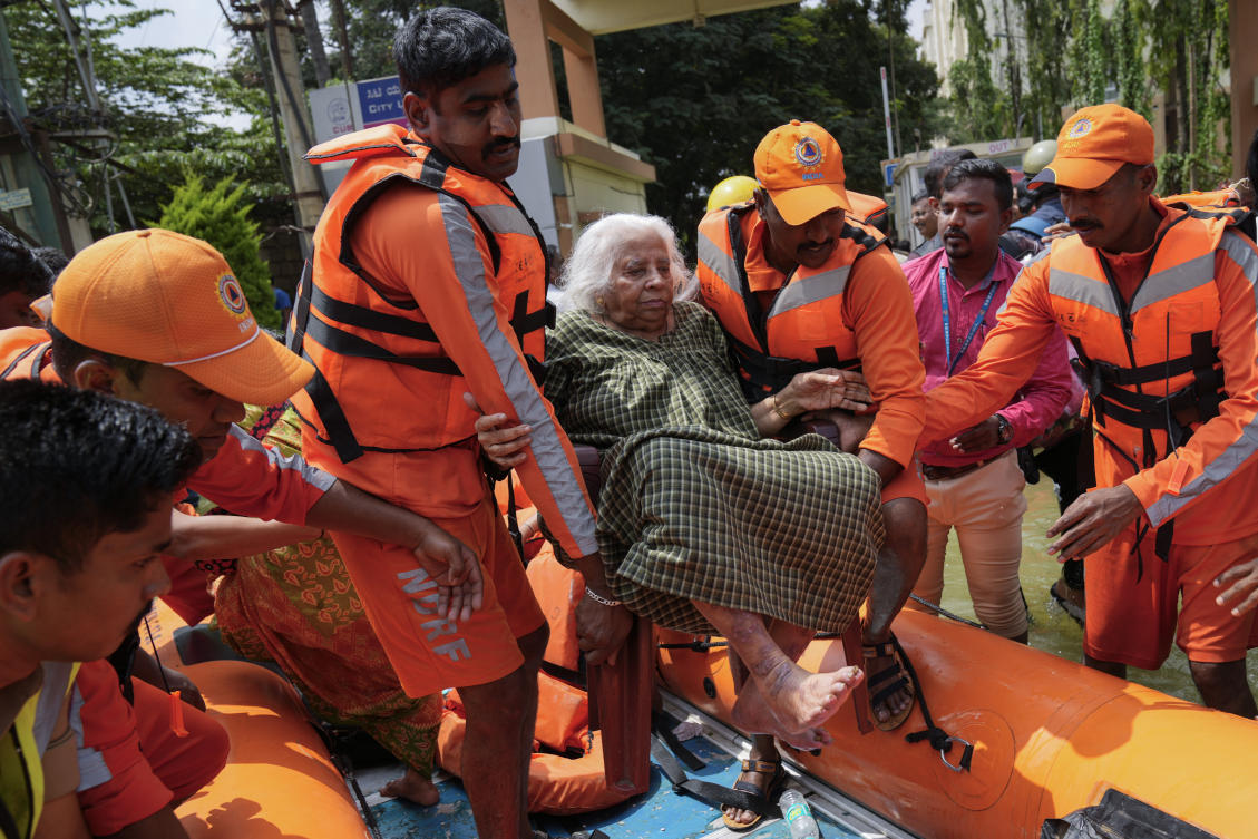 Above, a resident rescued from a flooded residential apartment due to heavy rains in Bengaluru, India on Oct. 22, 2024. (AP)