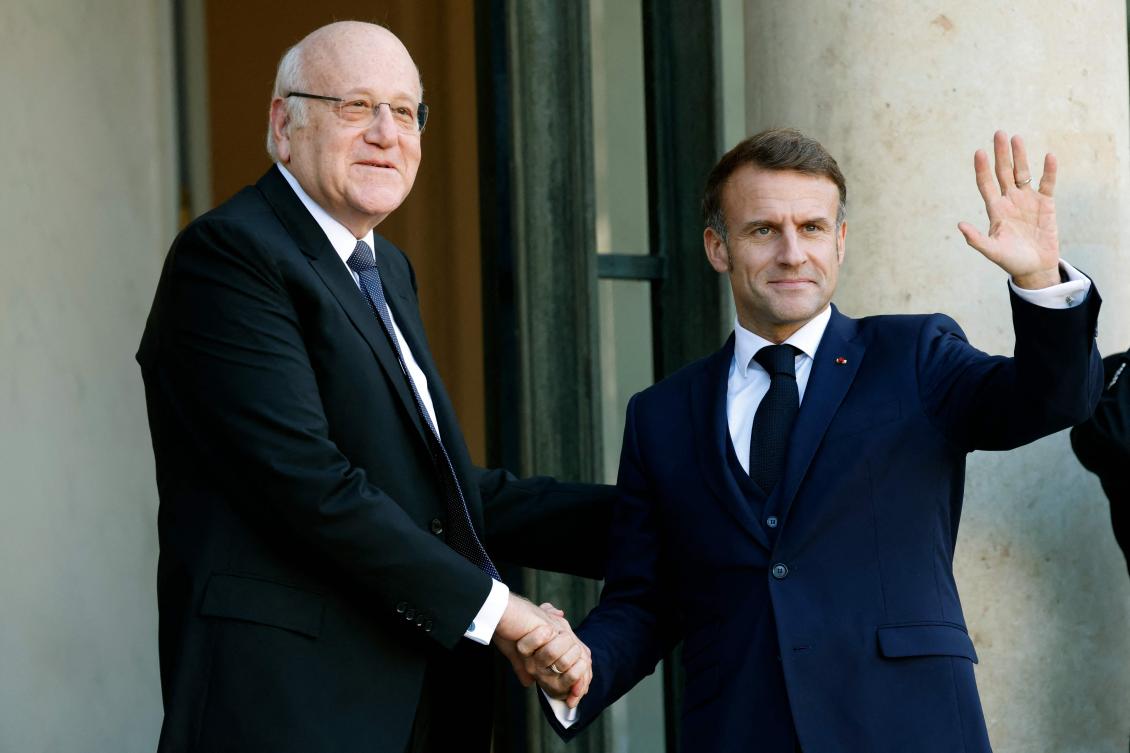 France’s President Emmanuel Macron (R) welcomes Lebanon’s Prime Minister Najib Mikati prior to their meeting at The Elysee Presidential Palace in Paris on October 23, 2024. (AFP)