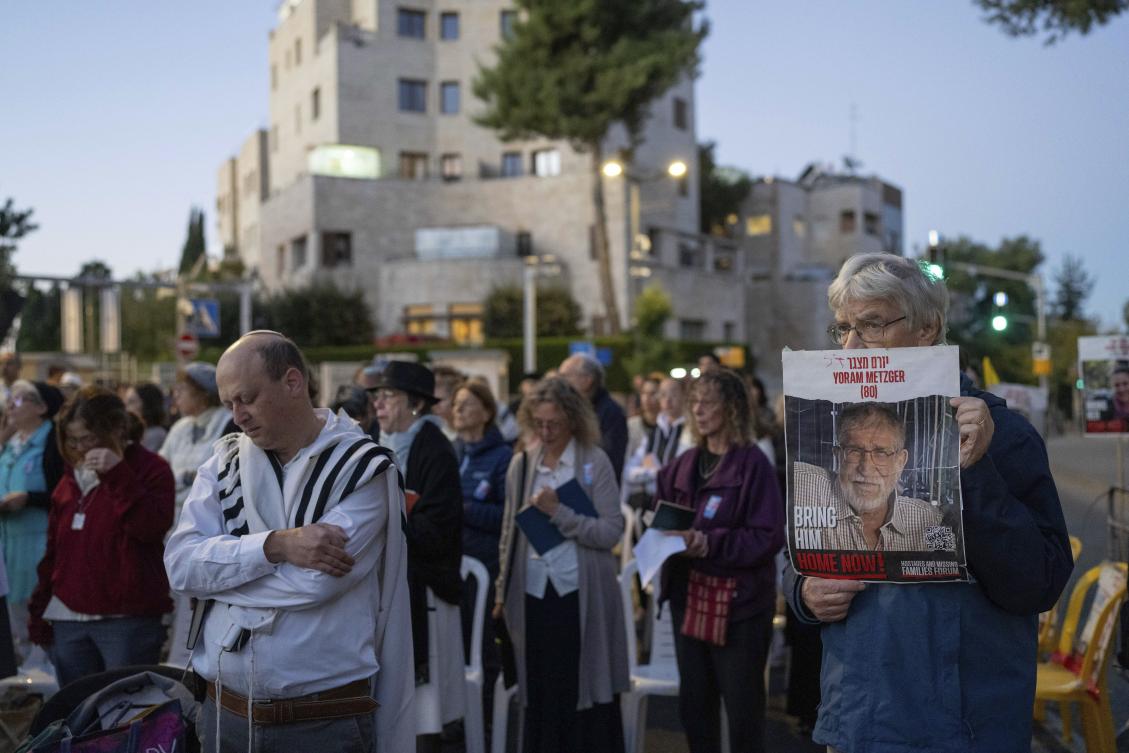 Families and supporters of Israeli hostages held by Hamas in Gaza pray outside the prime minister’s house in Jerusalem on the Jewish holiday of Simchat Torah, marking one year in the Hebrew calendar since Hamas militants attacked Israel, on Oct. 24, 2024. (AP)