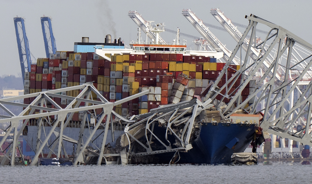 The cargo ship Dali is stuck under part of the structure of the Francis Scott Key Bridge after the ship hit the bridge, Tuesday, March 26, 2024, as seen from Pasadena, Md. (AP)