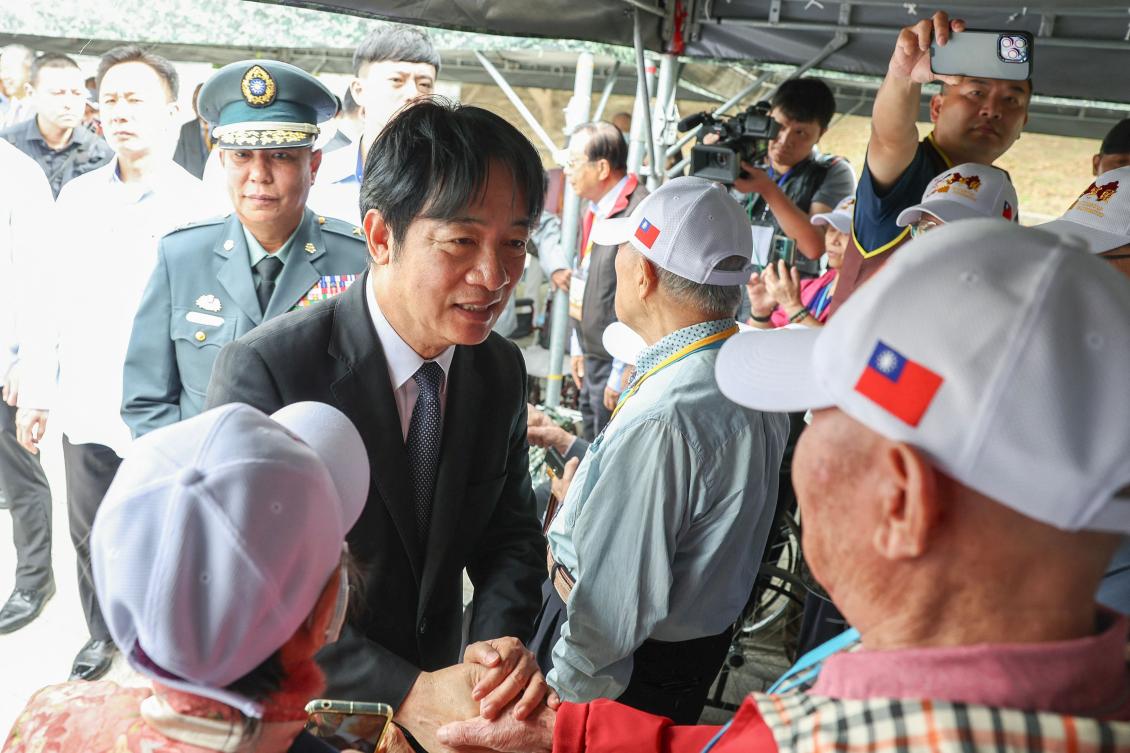 Taiwan’s President Lai Ching-te, left, shakes hands with veterans during a ceremony commemorating the 75th anniversary of the Battle of Guningtou in Kinmen on Oct. 25, 2024. (AFP)