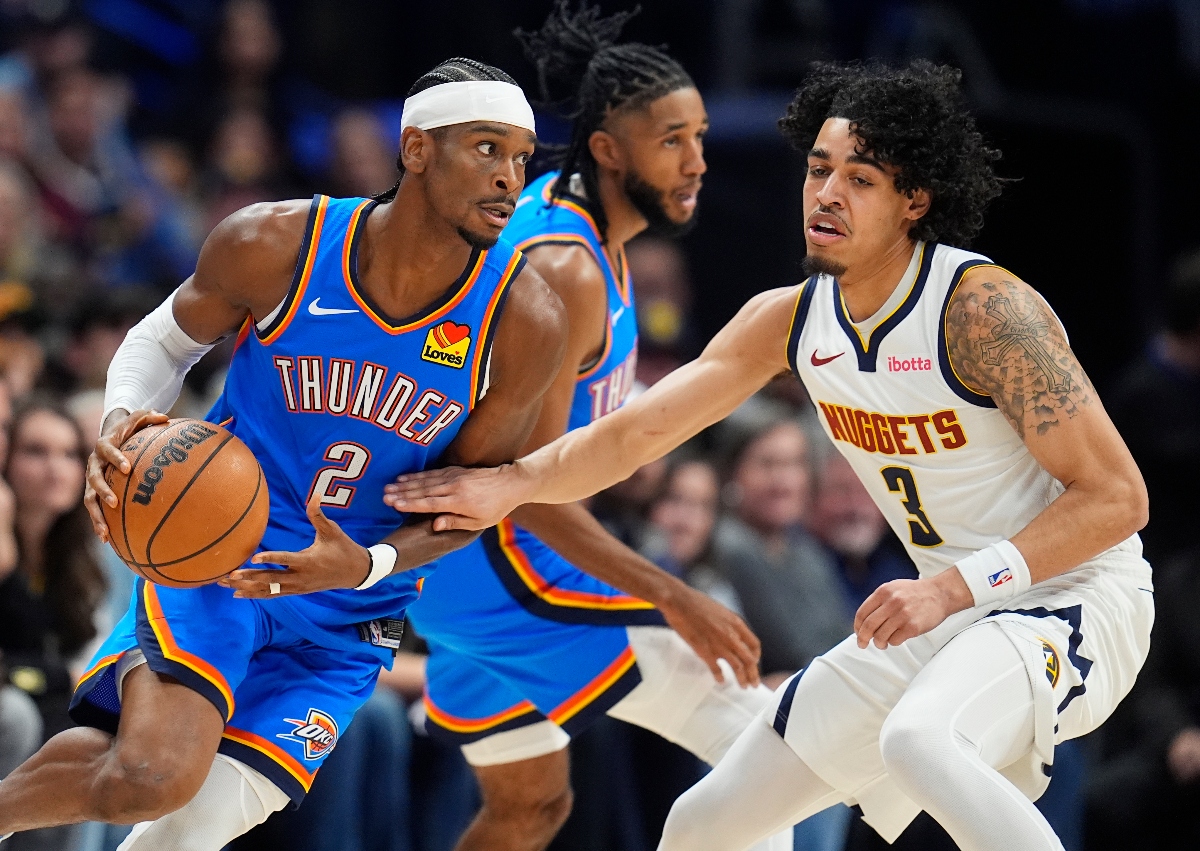 Oklahoma City Thunder guard Shai Gilgeous-Alexander drives past Denver Nuggets guard Julian Strawther, right, in the first half of an NBA basketball game Thursday in Denver. (AP)