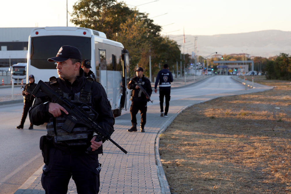 Turkish police officers secure part of a main road in Kahramankazan, some 40 kilometers north of Ankara on Oct. 23, 2024, in the vicinity of the Turkish Aerospace Industries building after a huge explosion outside its headquarters. (AFP)