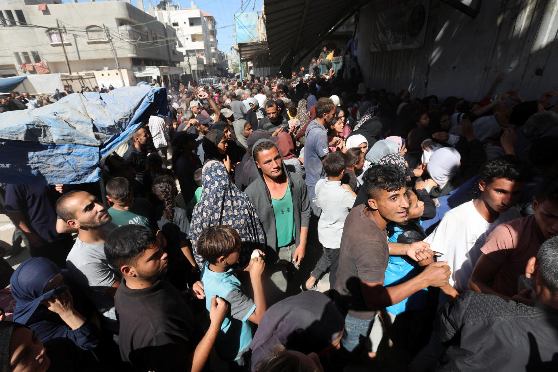 Palestinians gather to buy bread from a bakery, amid the Israel-Hamas conflict, in Deir Al-Balah in the central Gaza Strip Oct. 24, 2024. (Reuters)