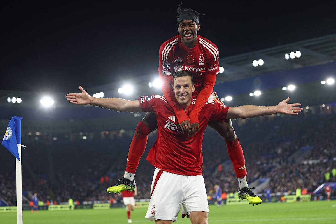Nottingham Forest's New Zealand striker Chris Wood celebrates with Nottingham Forest's Swedish midfielder Anthony Elanga (up) after scoring their third goal during the English Premier League match against Leicester City at King Power Stadium in Leicester, central England, Friday. (AFP)