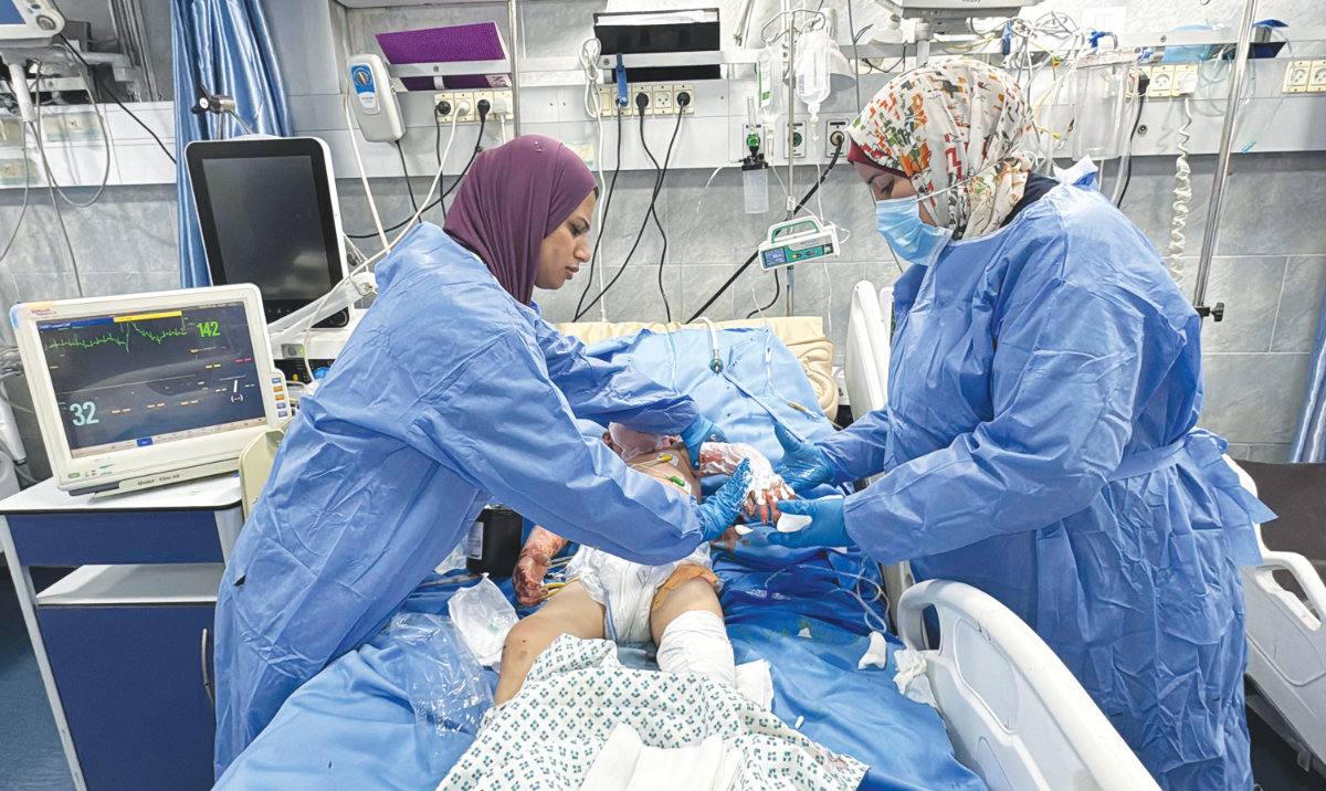 An injured infant receives medical care at the emergency room in the Kamal Adwan Hospital in Beit Lahia the northern Gaza Strip on Saturday. (AFP)
