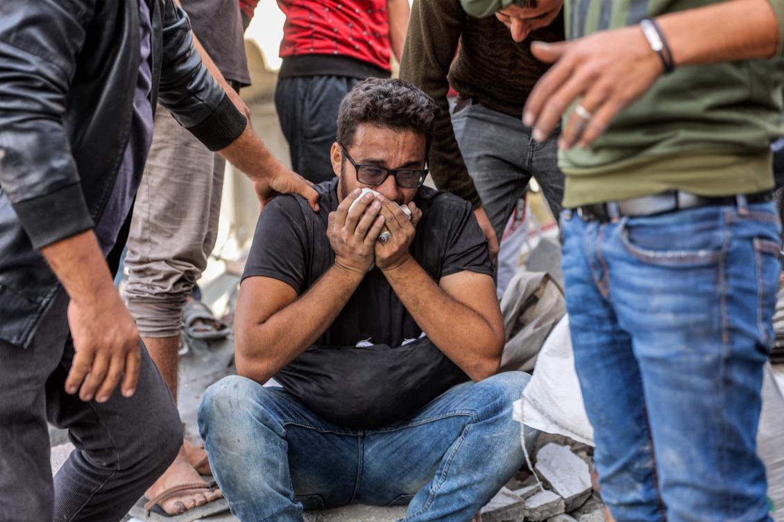 A man reacts while sitting atop rubble following Israeli bombardment on the four-storey Muqat family house in the Zarqa neighbourhood in the north of Gaza City on October 26, 2024. (AFP)