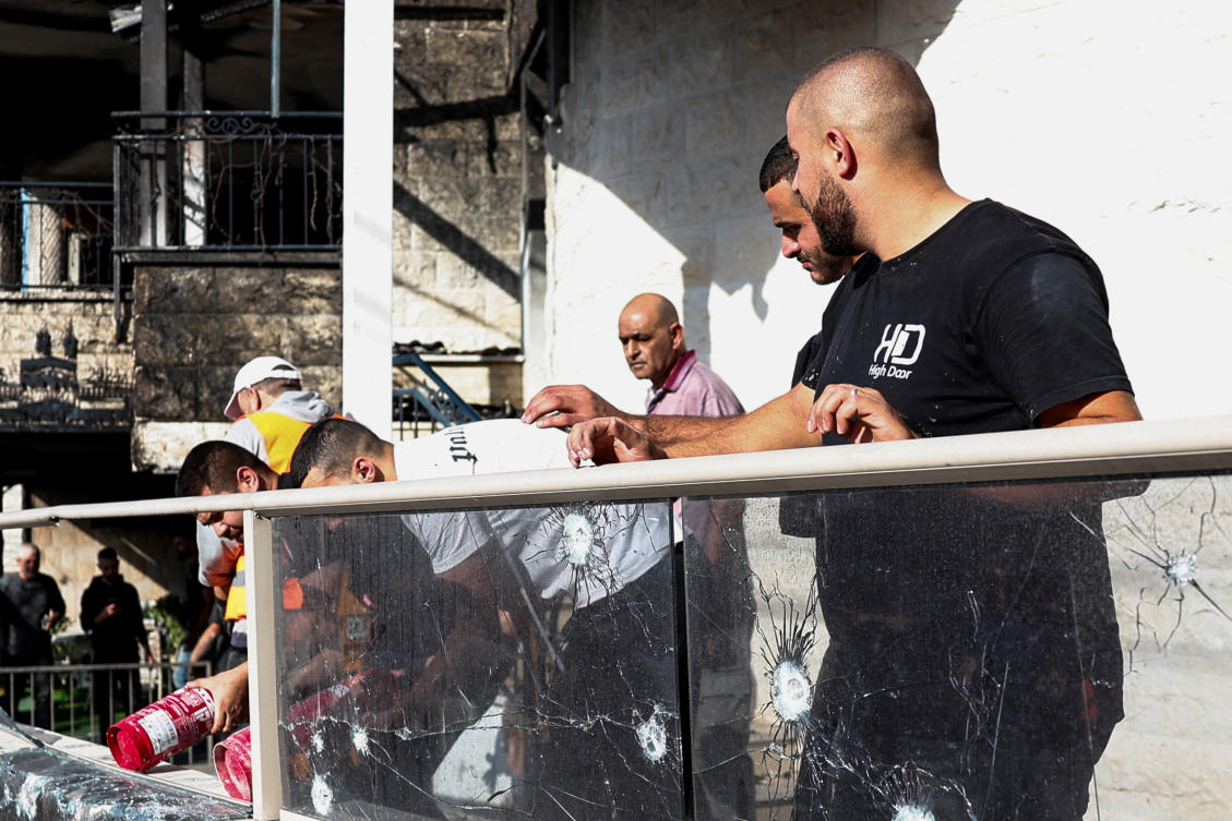 People inspect damages at a site of a house damaged after a barrage of rockets was fired from Lebanon into Israel in Tamra, northern Israel, on October 27, 2024. (Reuters)
