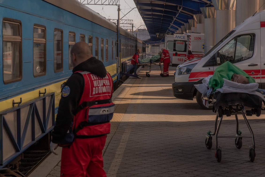 Injured Ukrainian soldiers are moved on stretchers from ambulances to a military evacuation train transporting Ukrainian servicemen wounded in frontline areas to hospitals, in an undisclosed location amid the Russian invasion of Ukraine. (AFP)
