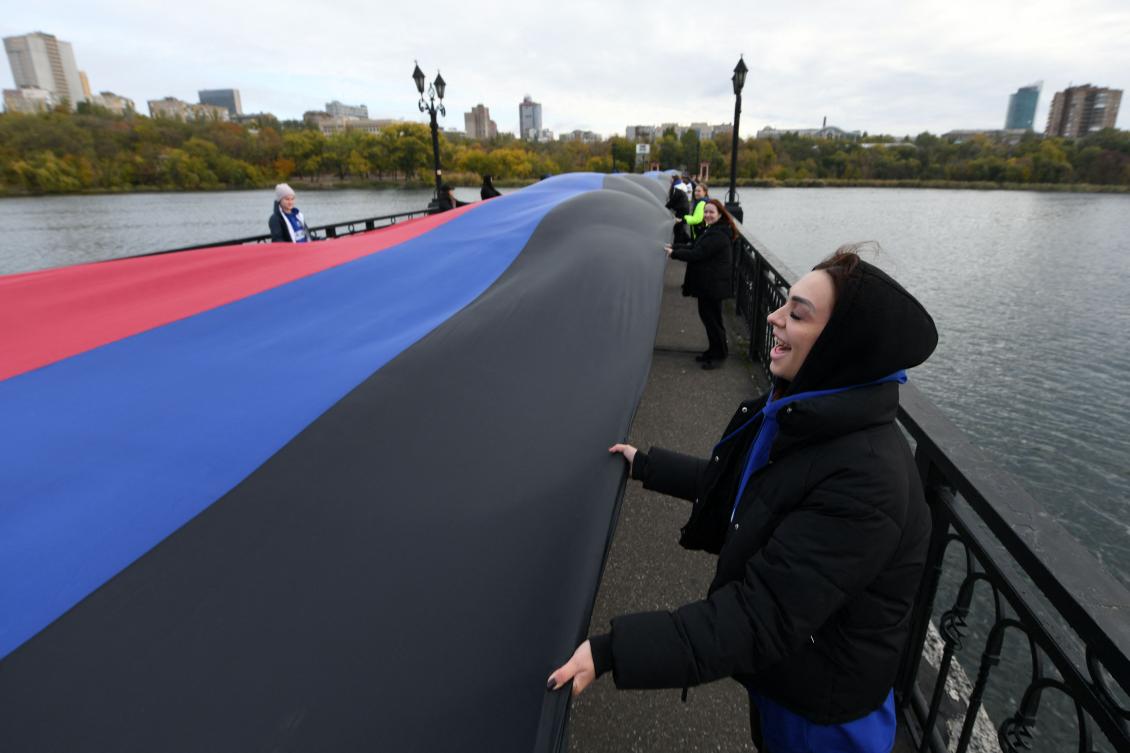 Activists unfold a giant flag of the Donetsk People’s Republic, to mark the Flag Day in Donetsk, Russian-controlled Ukraine, on October 25, 2024, amid the ongoing Russian-Ukrainian conflict. (AFP)