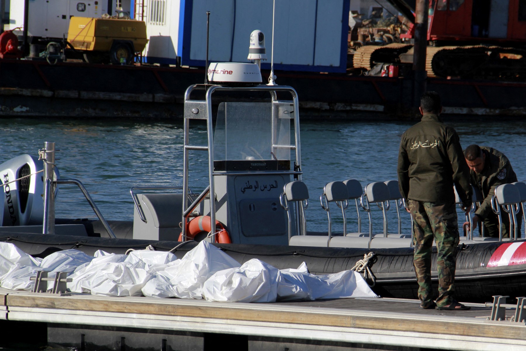 File photo Tunisia's coastguards retrieve the bodies of 20 migrants from sub-Saharan Africa after their boat capsized, at the port of Sfax in central Tunisia (AFP)