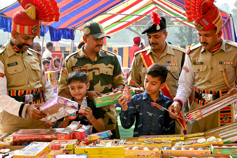India is readying for its major fireworks season, a traditional celebration for the Hindu festival of lights, Diwali, later this week. Above, border security personnel buy firecrackers with their children ahead of Diwali. (AFP)