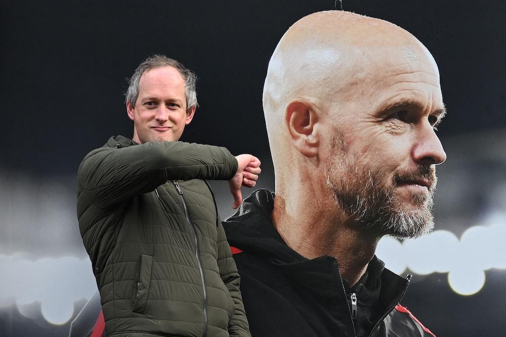 A visitor reacts as he poses in front of a picture of sacked Manchester United’s manager Erik ten Hag outside Old Trafford in Manchester on Oct. 28, 2024. Ten Hag had fiercely defended his record in recent weeks after winning two trophies in his two full seasons in charge. (AFP)