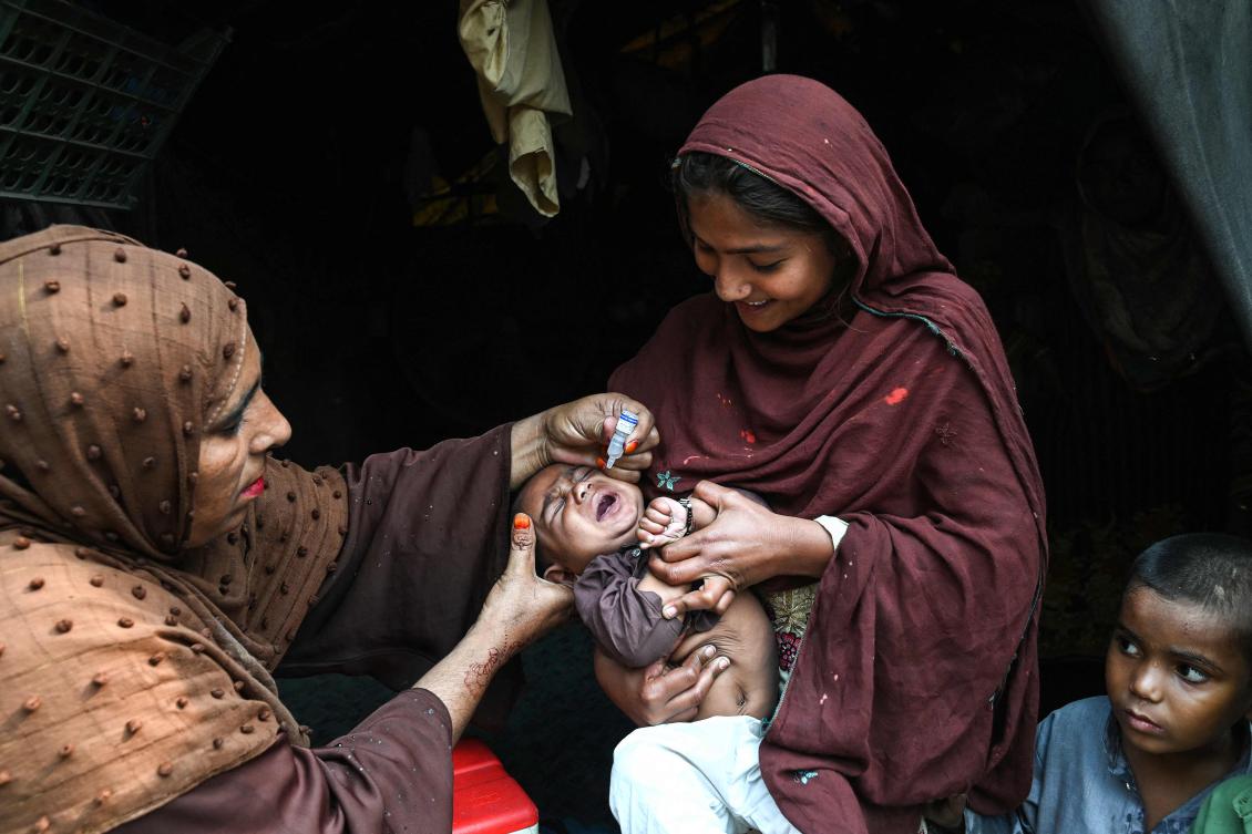 A health worker administers polio drops to a child during a door-to-door vaccination campaign in Lahore on October 28, 2024. (AFP)
