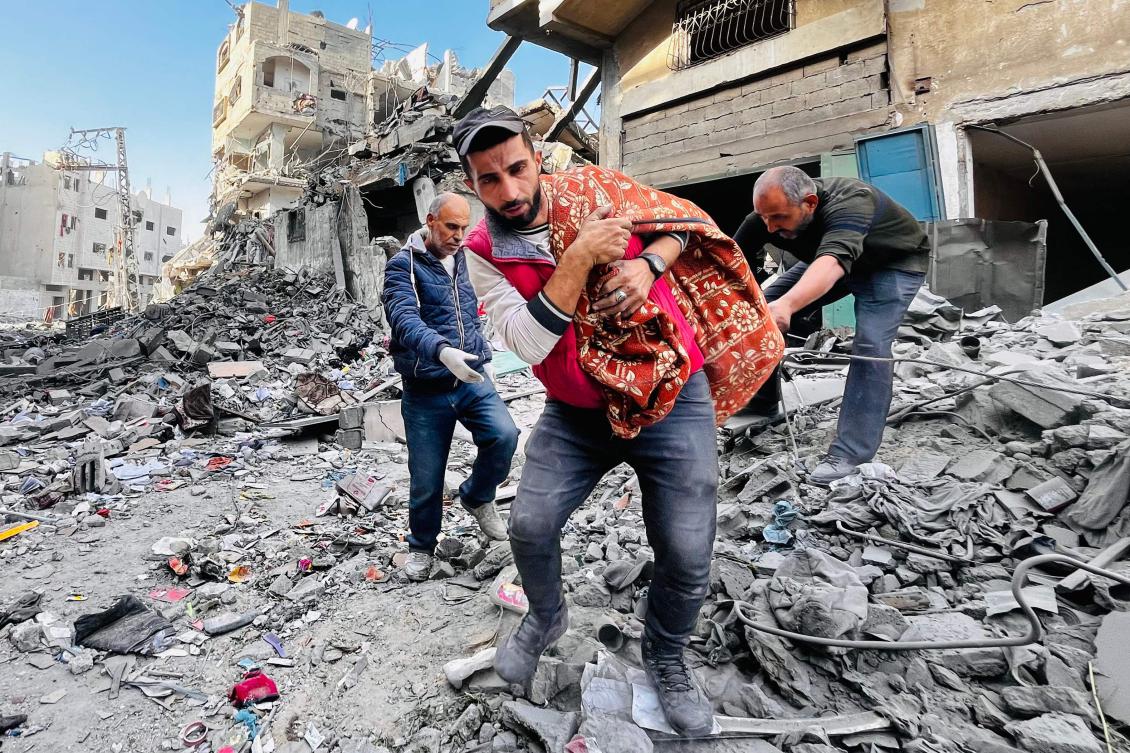 Residents remove a body from the rubble of a building hit by an Israeli strike in Beit Lahia, in the northern Gaza Strip on Oct. 29, 2024. (AFP)