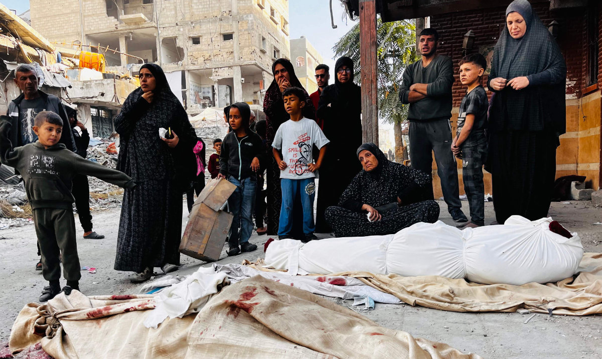 Palestinian mourn over the bodies of relatives after an Israeli strike in Beit Lahia, in the northern Gaza Strip, on October 29, 2024, amid the ongoing war in the Palestinian territory between Israel and Hamas. (AFP)