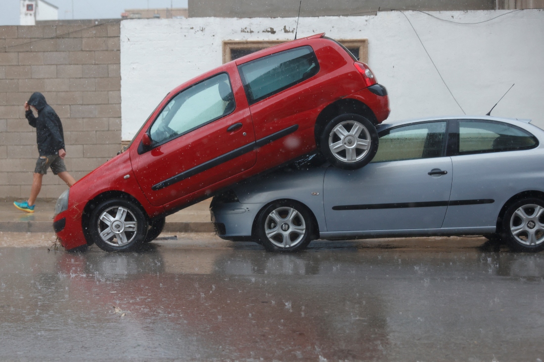 A car sits partially on top of another after the Spanish meteorological agency put the Valencia region in the highest red alert for extreme rainfalls, in Llombai, Valencia, Spain. (REUTERS/Eva Manez)