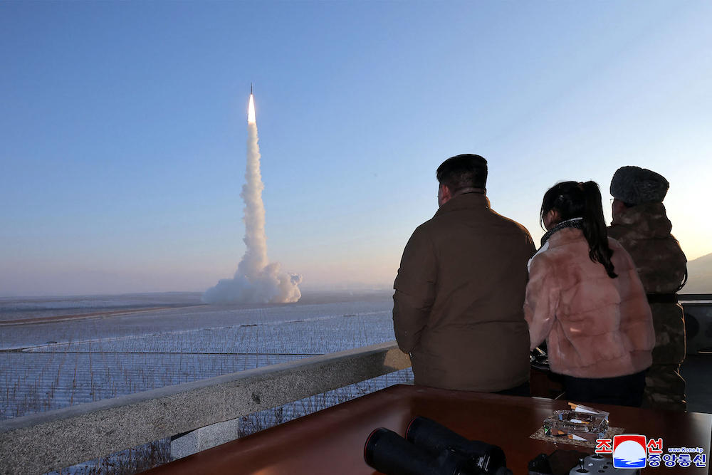 North Korean leader Kim Jong Un, left, and his daughter watch the test launch of a Hwasongpho-18 intercontinental ballistic missile at an undisclosed location in North Korea in this undated picture released on Dec. 19, 2023. (KCNA via KNS/AFP file photo)