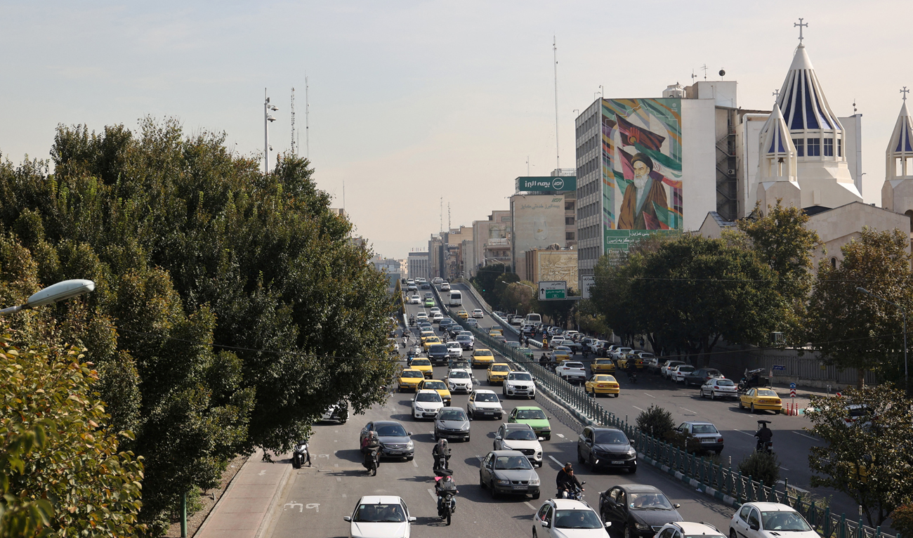 Cars pass on a street after several explosions were heard, in Tehran, Iran, October 26, 2024. (REUTERS)