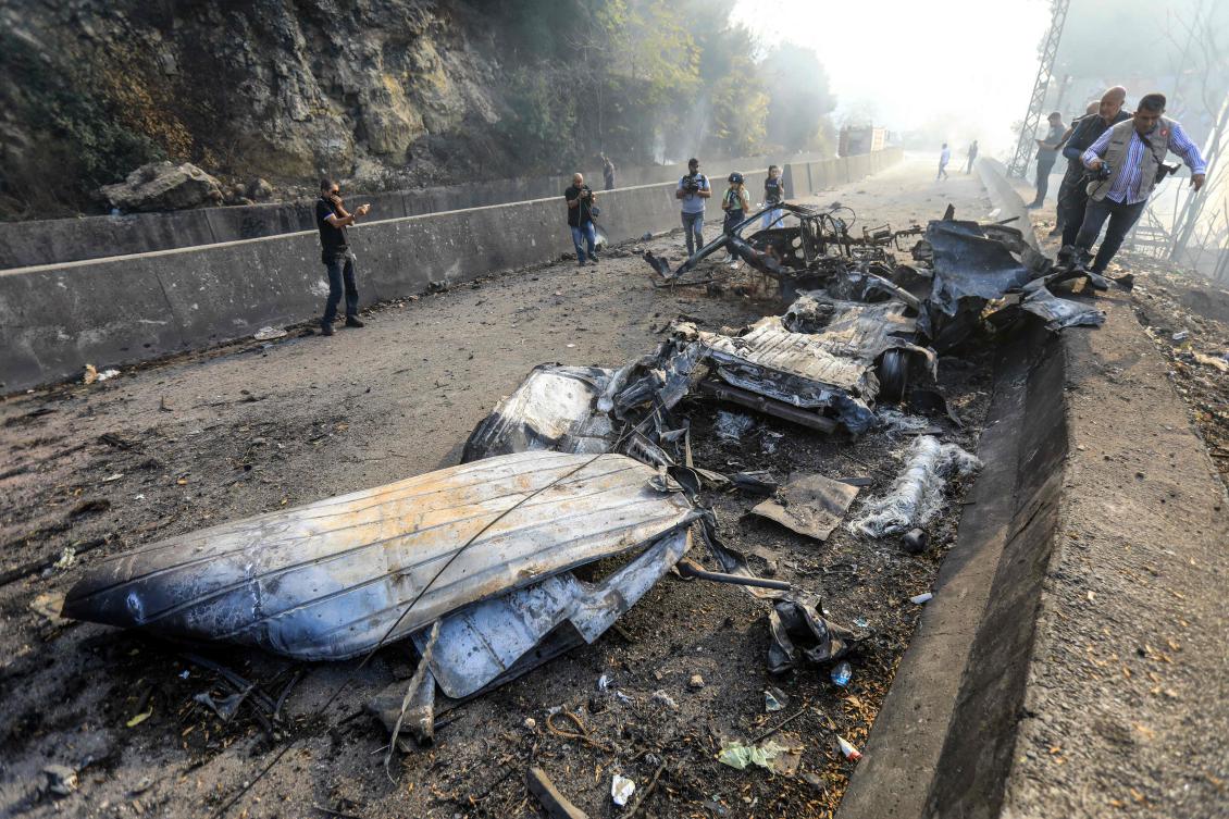 The wreckage of a vehicle lies on the Araya-Kahhale road on October 30, 2024, at the site of an Israeli strike. (AFP)
