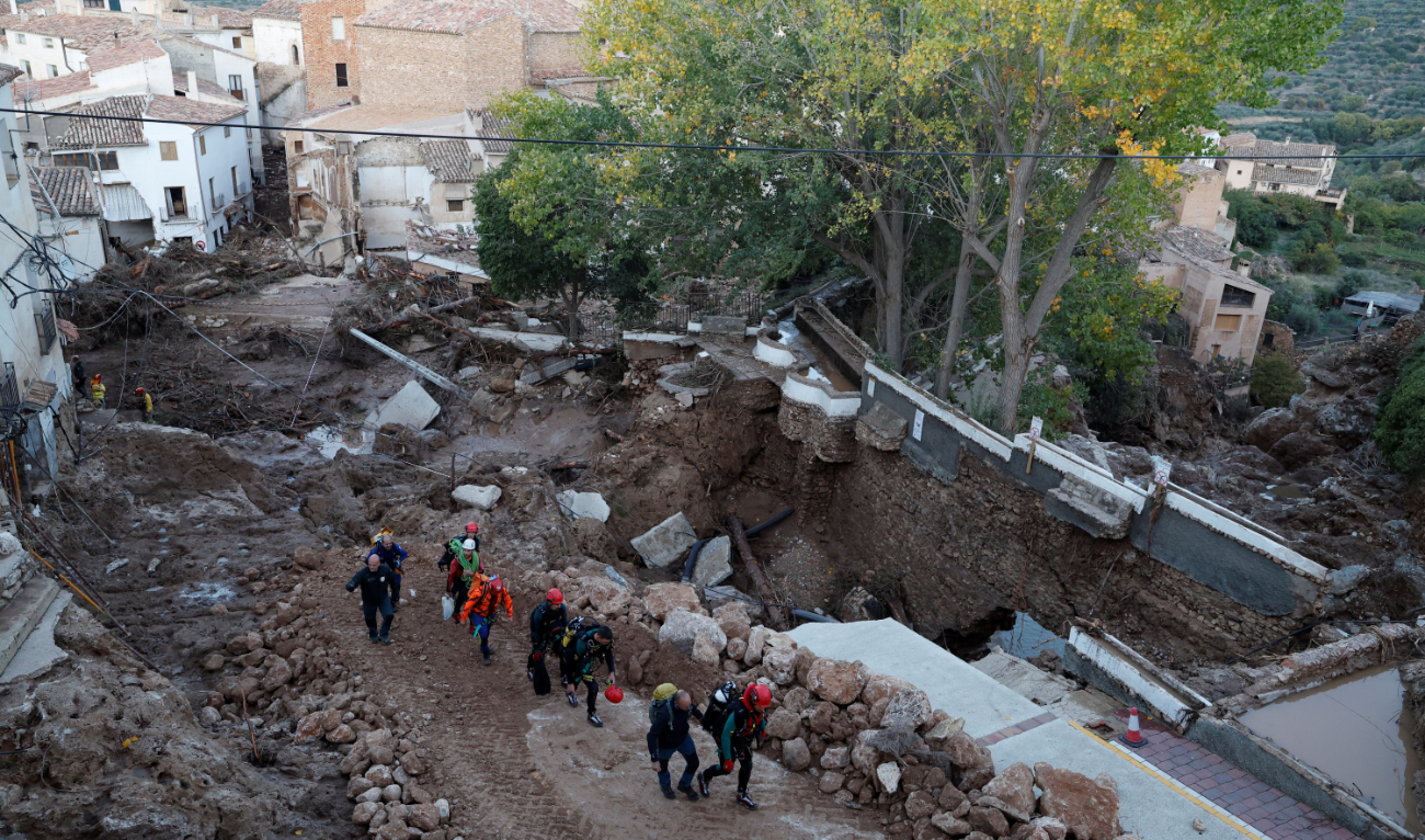 Emergency services staff members walk in a street devastated following floods in Letur, southwest of Valencia, eastern Spain, on October 30, 2024. (AFP)
