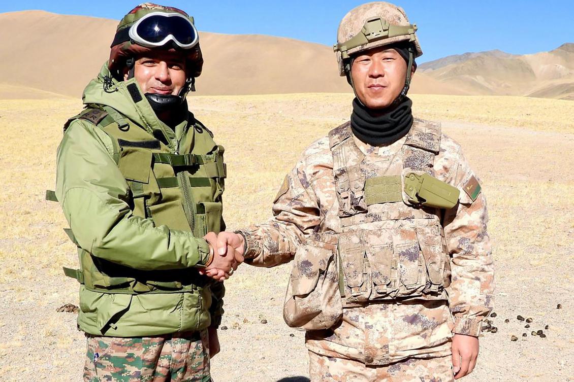 Above, Indian and Chinese army greet each other along the Line of Actual Control near Karakoram pass in Ladakh on Oct. 31, 2024. (Indian Army/AFP)